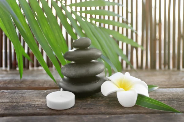 Spa stones with palm leaves