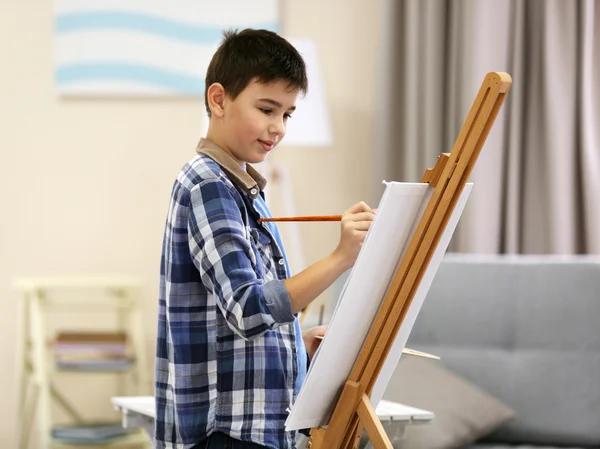 Boy drawing on easel