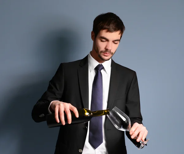 Man pouring red wine into a glass