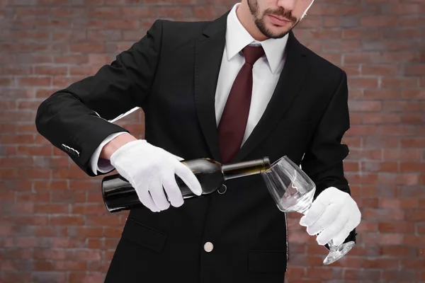 Man pouring red wine into a glass