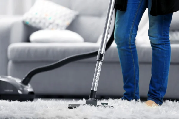 Woman cleaning the carpet