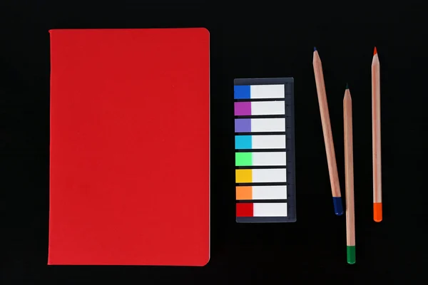 Notebook with coloured pencils and ruler