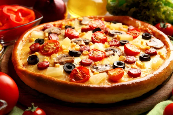 Delicious pizza with vegetables and meat, close-up