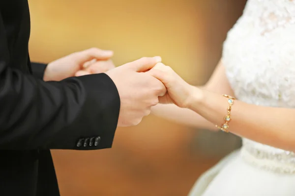 Bride and groom holding hands