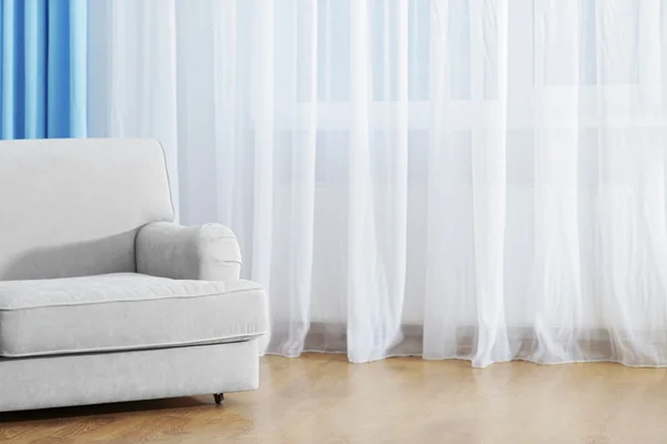 Sofa in room with curtains