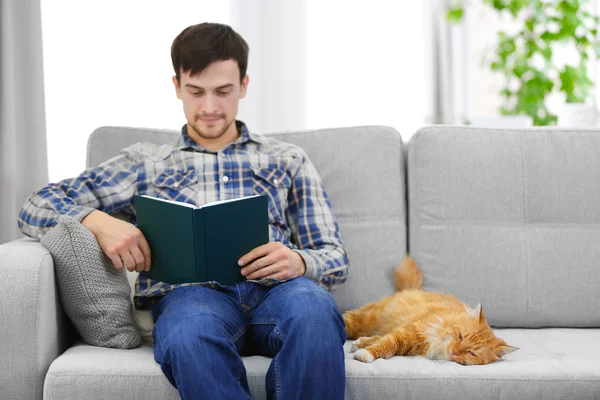 Reading man with fluffy rad cat