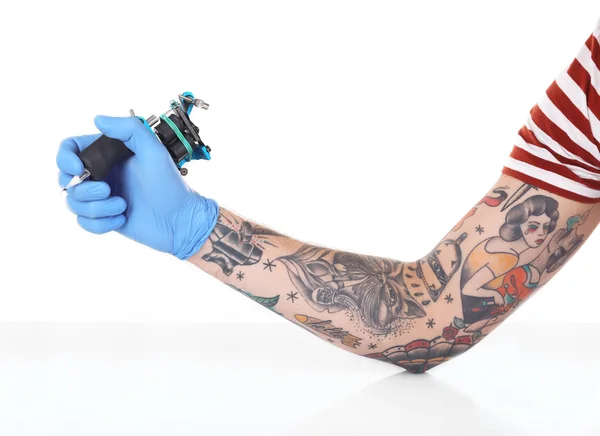 Tattooist hand with tattoo machine