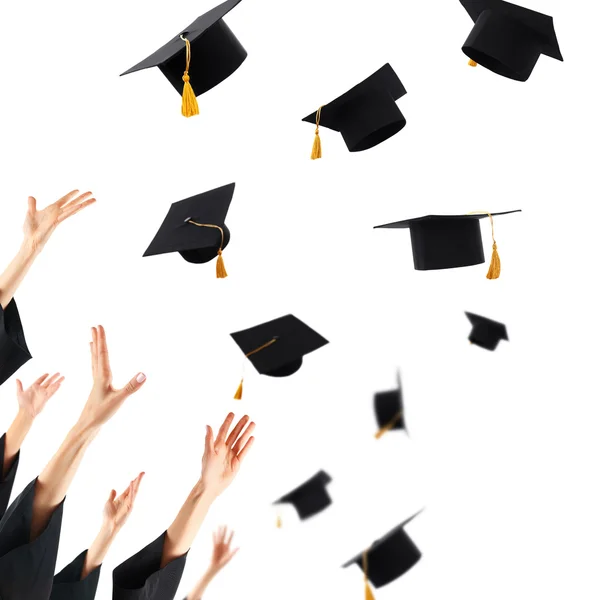 Graduates hands throwing graduation hats