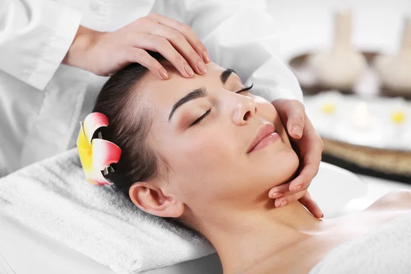 Woman relaxing with face massage