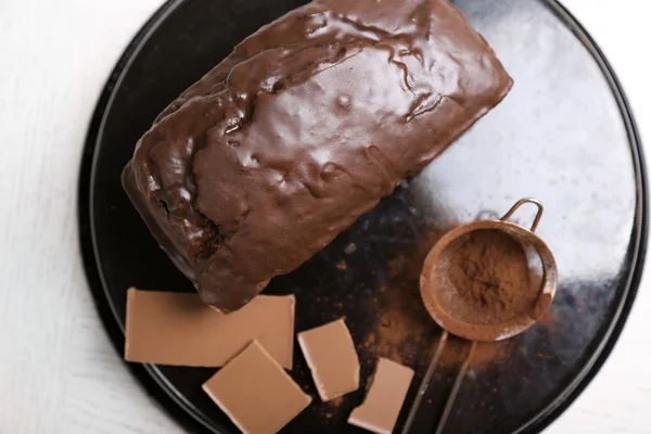 Chocolate cake with icing and cocoa powder