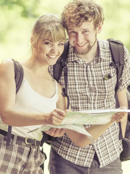 Couple reading map on trip.