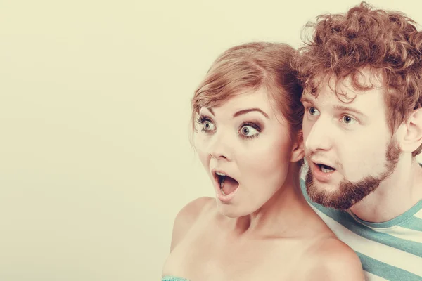 Wide eyed couple surprised expression open mouth