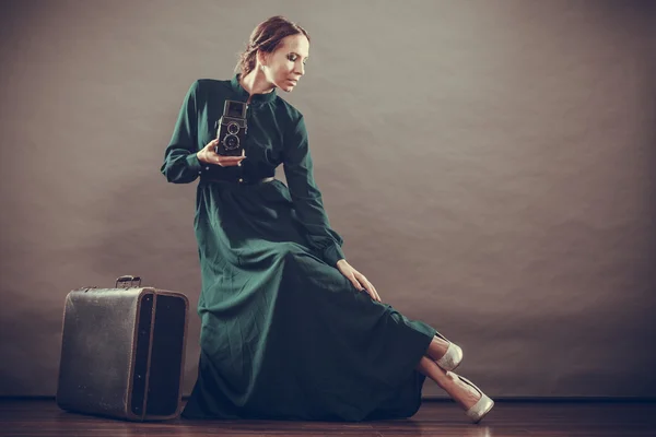 Woman retro style with old suitcase camera