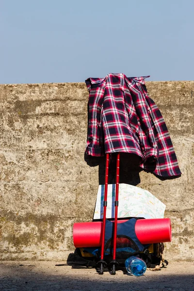 Plaid shirt with hiking gear.