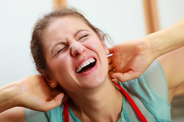 Overworked woman suffering from neck pain.