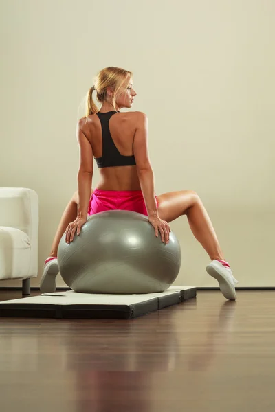 Woman doing fitness exercises with fit ball