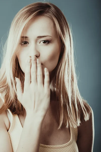 Surprised woman face covering her mouth with hand