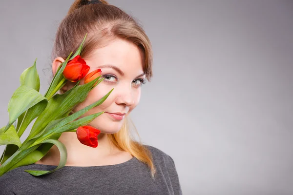 Girl with red tulips