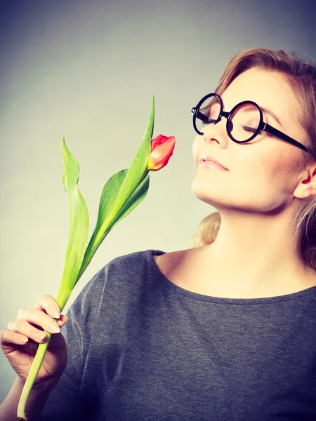 Charming woman smelling flower feel peace.