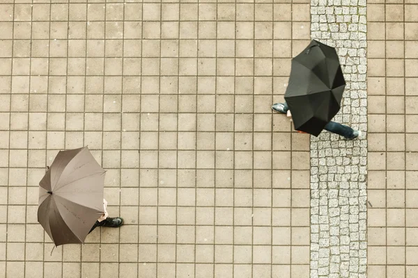 People with umbrellas.