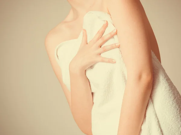 Woman covering breast under towel.