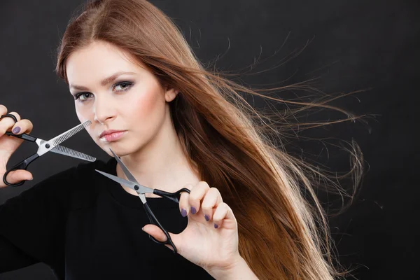 Female hairstylist barber with scissors.