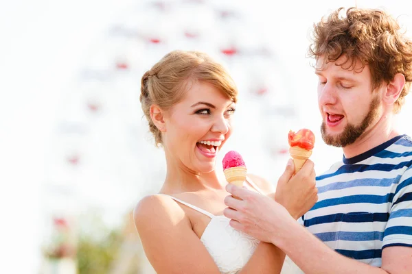 Young couple eating ice cream outdoor