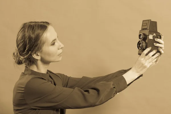 Woman taking picture with old camera