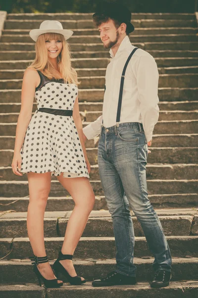 Loving couple retro style flirting on stairs