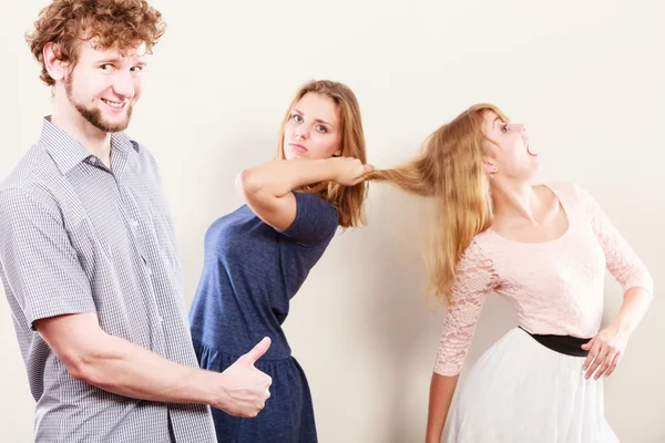 Aggressive mad women fighting over man.