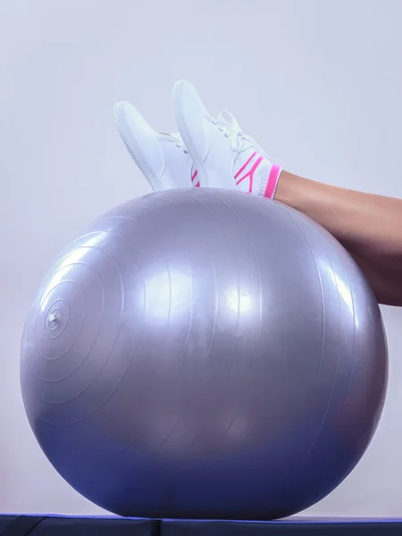 Woman doing fitness exercises with fit ball