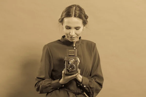 Woman taking picture with old camera