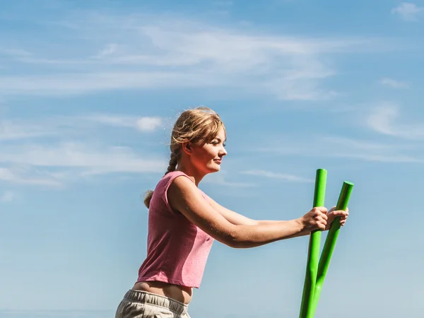 Woman exercising on elliptical trainer