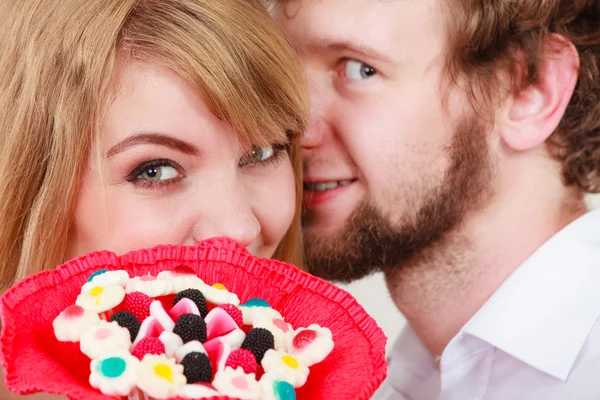 Man whispering to woman ear sharing secret.