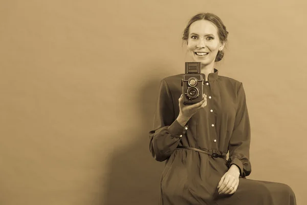 Woman taking picture with old camera