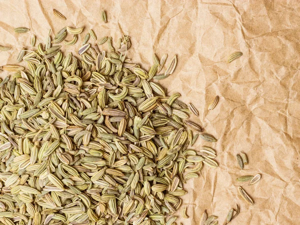 Heap of fennel dill seeds on paper surface