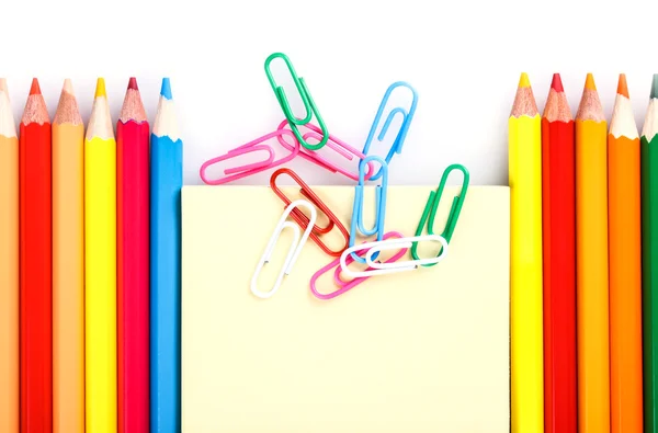 Set of colored pencils and paper clips