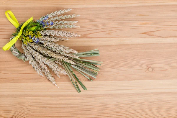 Bundle of wheat with flower and band