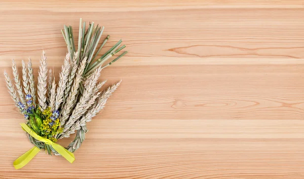 Bundle of wheat with flower and band