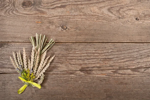 Bundle of wheat with flower and band