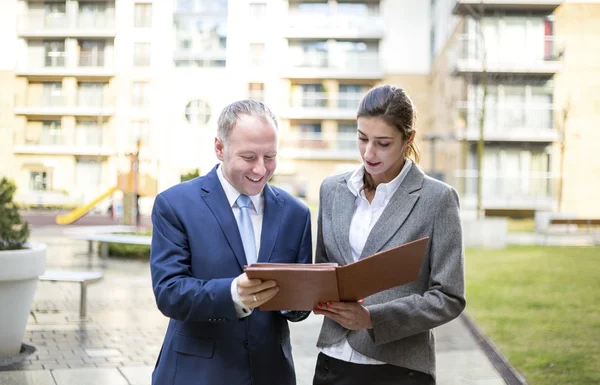 Two business people discussing outside the office