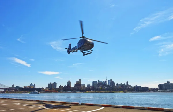 Black Helicopter taking off from helipad in Lower Manhattan