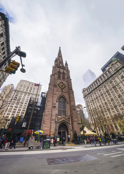 Trinity Church in Manhattan and street with tourists