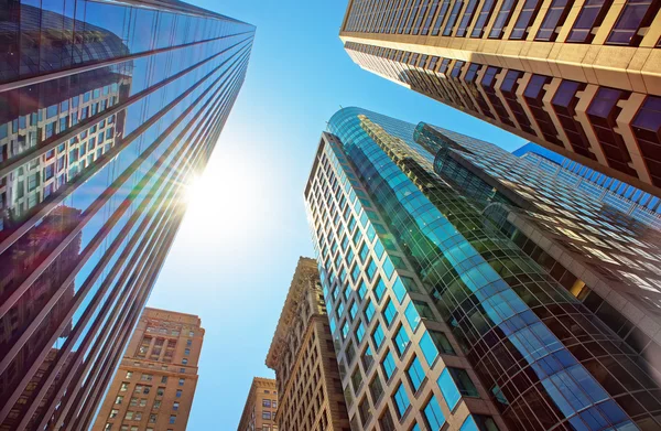 Bottom-up view of skyscrapers mirrored in glass in Philadelphia