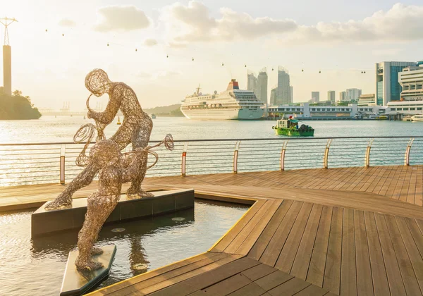 Sculptures of Jazz Players and Singapore Cruise Center at sunset