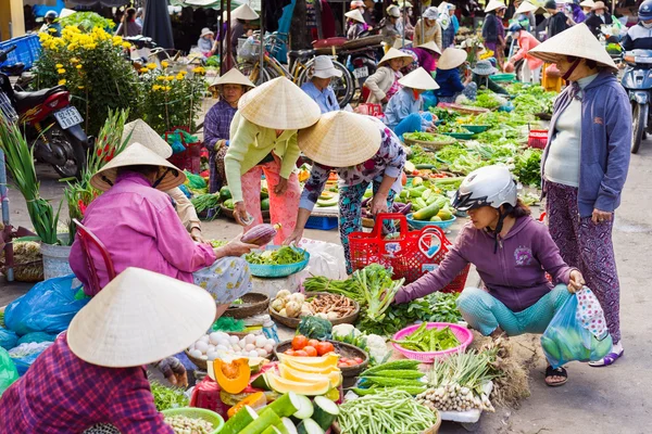 Asian traders selling fresh vegetables in the street market