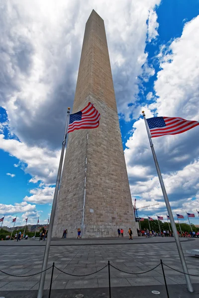Washington monument surrounded by the flags of the US
