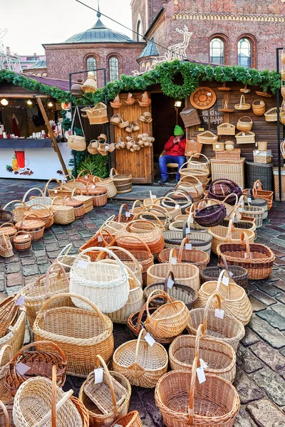 Christmas market stall with straw baskets for sale in Riga