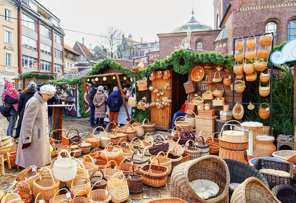 Christmas market stall with wicker baskets for sale in Riga