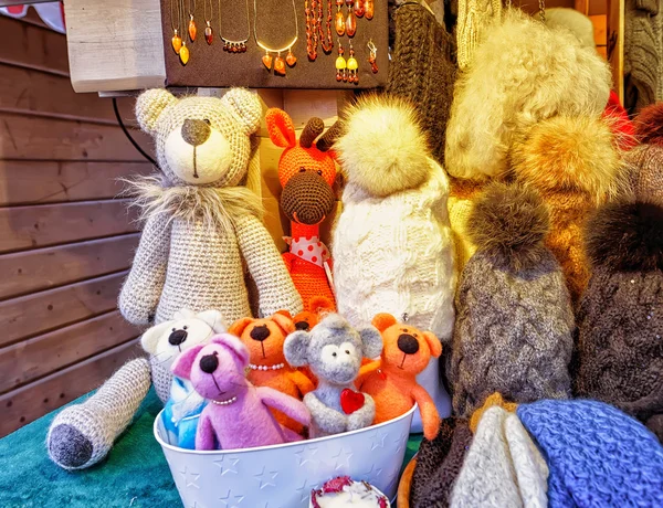 Handmade bears and hats displayed at Riga Christmas market